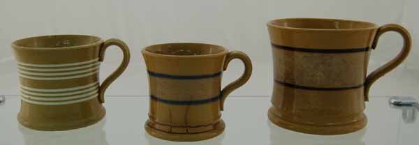 3 Yelloware banded mugs: Brown banded mug is 3 3/4" tall, very good condition. White banded mug is 3" tall, excellent condition. Blue banded mug 3" tall, poor condition