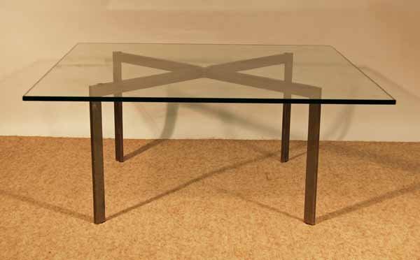 Mies Van der Rohe for Knoll Barcelona Table: 40" wide x 40" deep x 17" tall. Stainless steel base, plate glass top. There is a chip out of the corner of the glass and the base needs polishing.