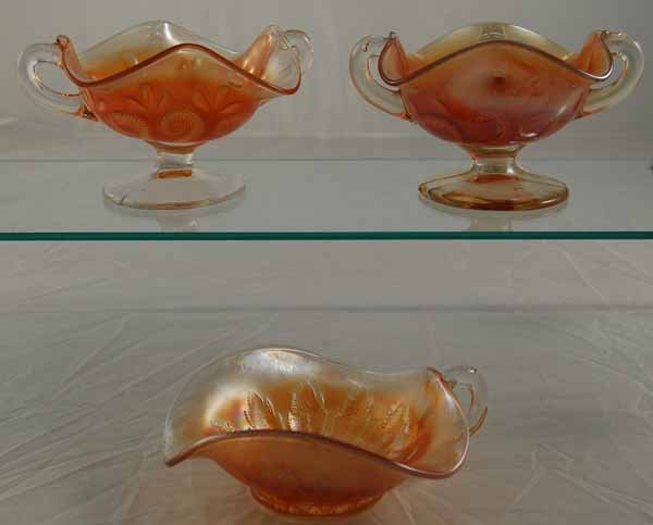 Three Pieces of Dugan Carnival Glass: Two "Question Marks" Compotes and a "Leaf Rays" Nappy Spade Shape Bowl all in good condition.