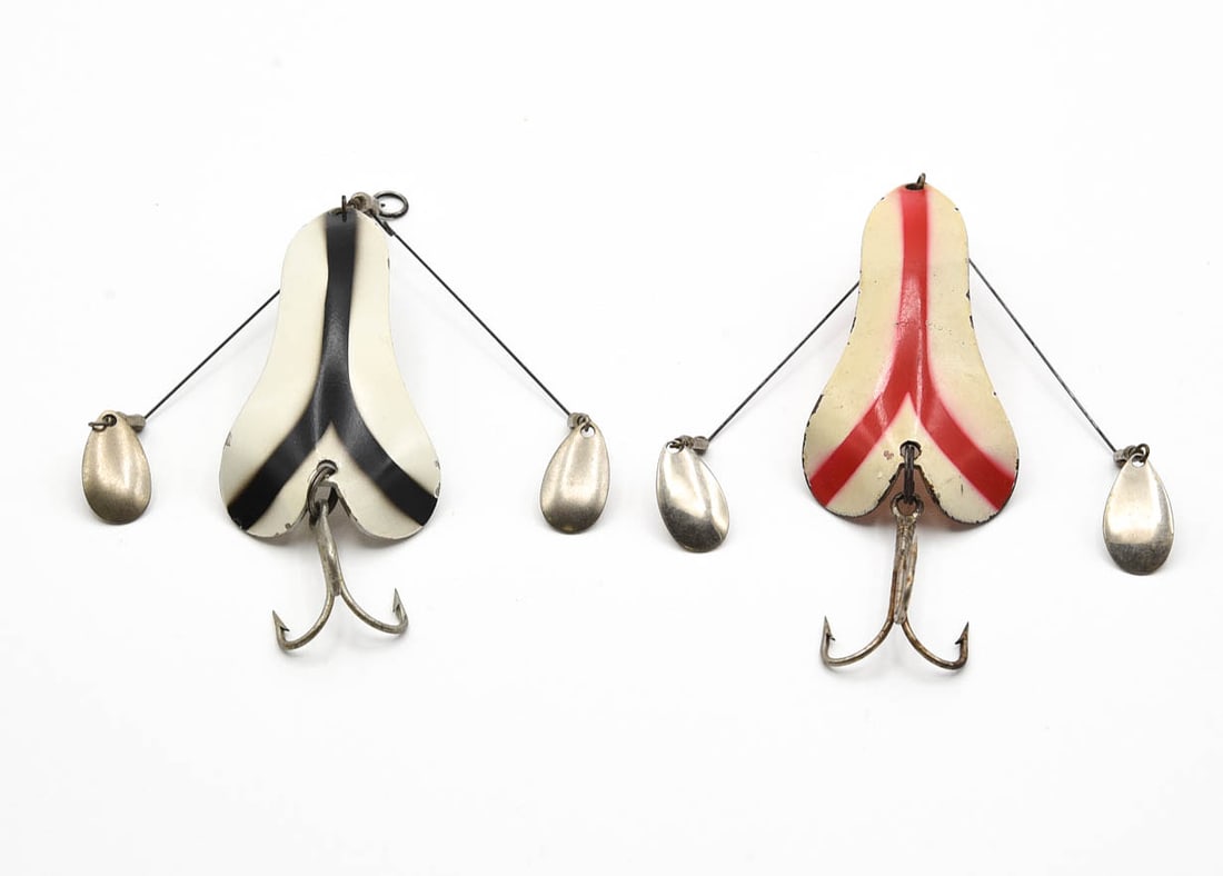 2 Creek Chub Sinful Sal: Painted models, each with the original spinner weed guards. White and red with a copper back grades VG+/Ex- due to common edge nicks, the white and black with a nickel back is Ex-.