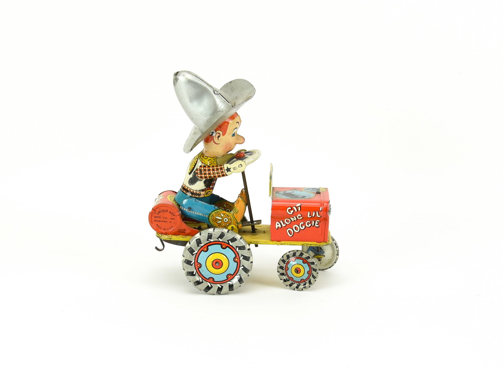 Unique Art Rodeo Joe Wind up Tin Toy: Git Along Lil Doggie. Winds up and is in working order. Reminants of the original box. 7" L.