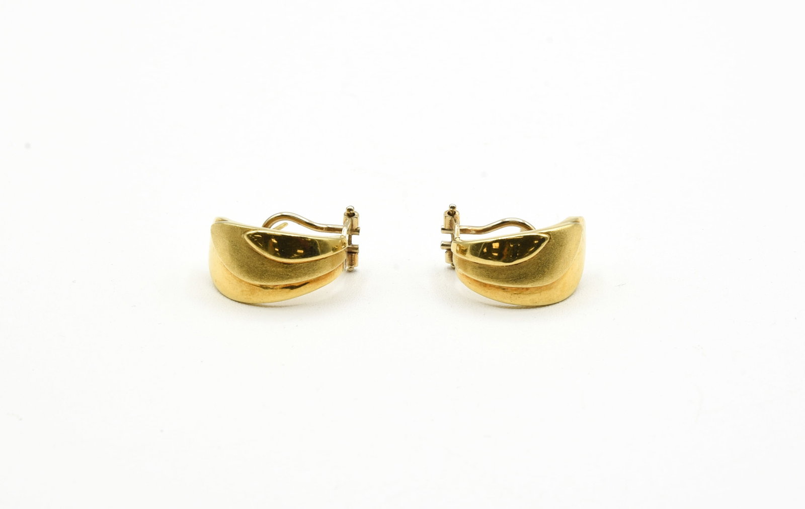 18kt Gold Earrings - 9.4 grams: Pair of post with Omega back earrings are 18K white gold and weigh a total of 9.4 grams. These are 3/4" x 3/8" solid semi-hoops with a bright and matte finish.