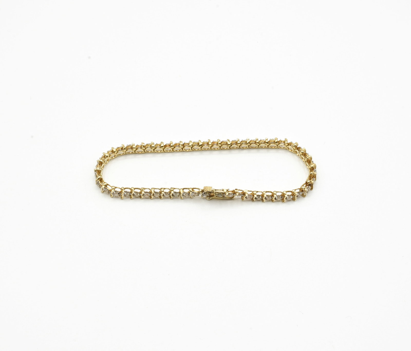10kt Gold Tennis Bracelet with Quartz: Marked 10k. 7 inches long. Total weight of 4.6 dwt.