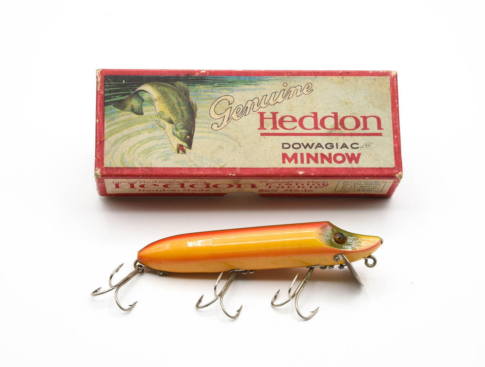 Heddon 7501 Vamp: Finished in bright rainbow, L-rig, red belly stencil, marked lip, shiny Ex-. The down bass box grades VG+/Ex-, end stamped 7509L Vamp.