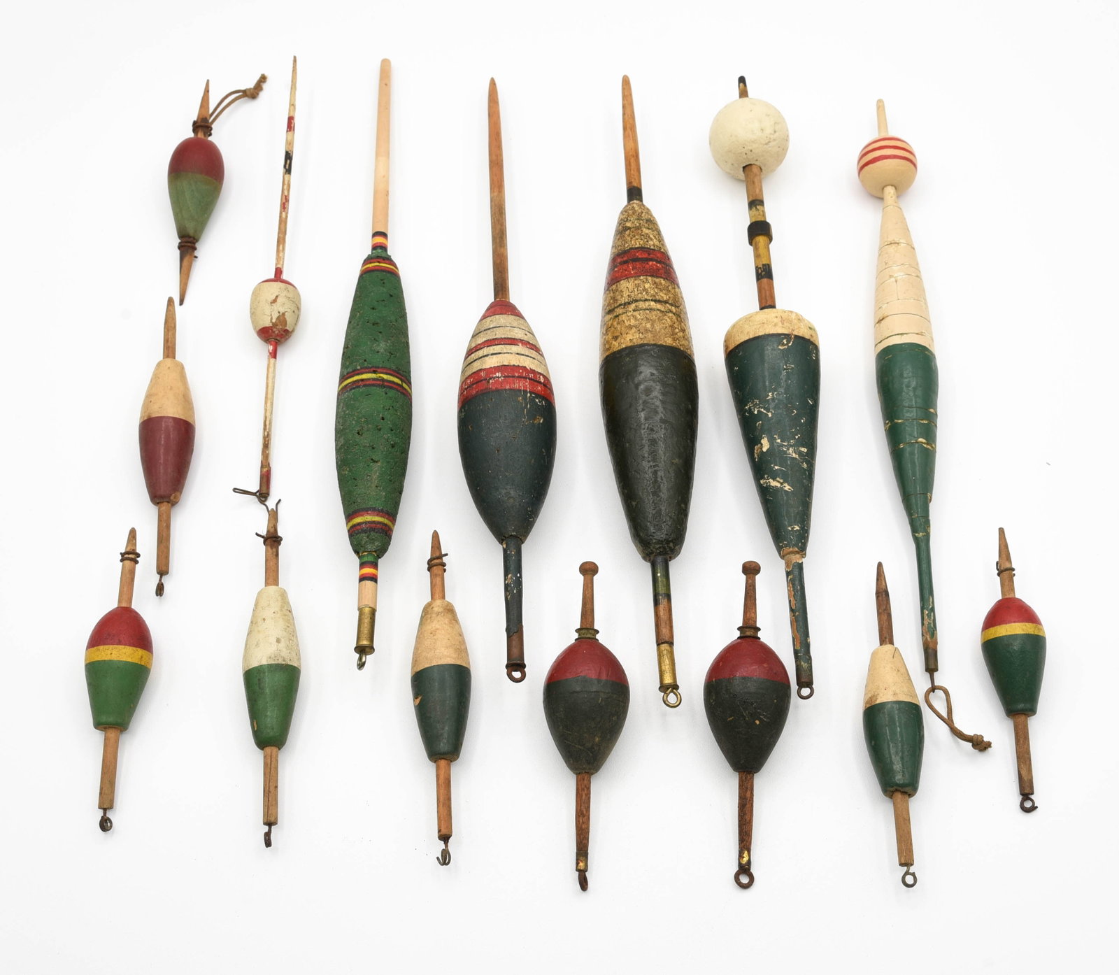 15 Old Floats: In a wide range of sizes, colors and ages, multiple different makers, from 4" to 11" in length. All have wear and/or soiling, condition from good to near Ex. The smallest bobbers were most likely sold