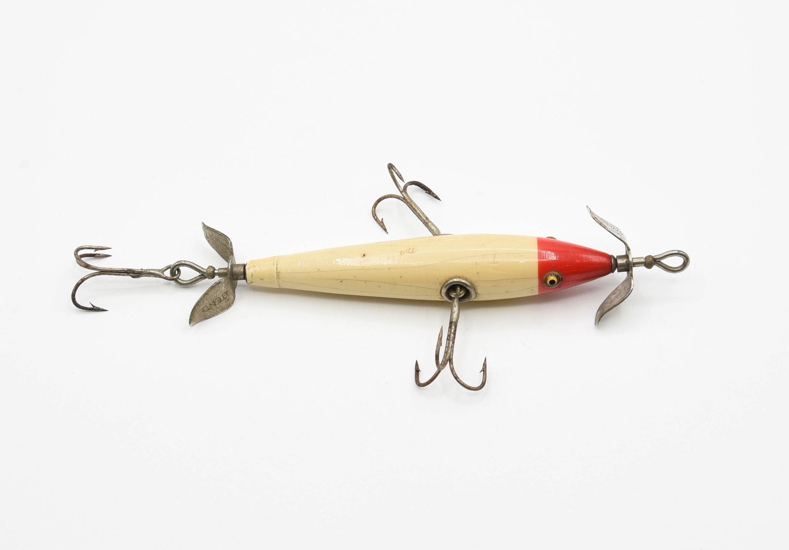 South Bend Panetella Minnow: Painted tail cap model with good glass eyes, blunt marked props, and finished in red head white, VG+/Ex- with wear, ring around the belly weight, a few tiny flakes, age lines and light soiling.