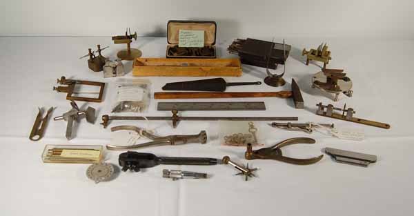 Watchmaker and Jewelers Tools: over 2 dozen tools including brass escapement matching tool, adjustable stands, hand vice, jewelers hammer, 6"" Lufkin machinist square, several brass & iron pocket watch tools, clock hand remover, po