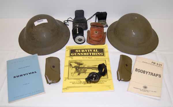 US Military Items: 2 Army Helmets, 3 Compass, 2 pair military sunglasses, Air Force "Survival" Book 1969, Army field manual "Booby Traps" 1965, Book titled "Survival Gunsmithing" by JB Wood. Provenance: from the Thomas