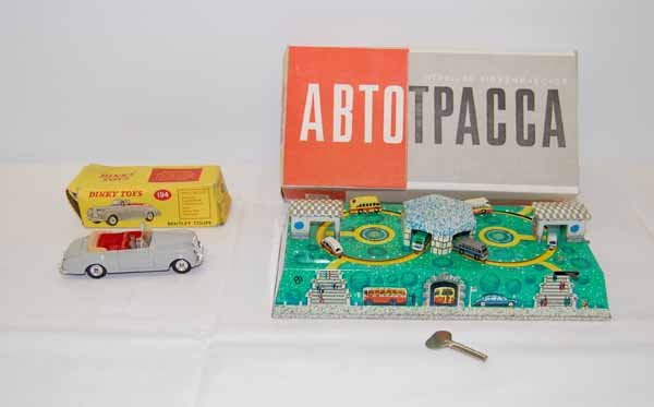 Dinky Toys Bentley Coupe & Abtotpacca Toy: Dinky Toys Bentley Coupe No.194 in original box along with Russian tin wind up toy with buses in original box with key. Toy is in new condition and there is a tear in the bottom of the box.Provenance: