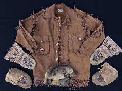 Abercrombie Leather Jacket, Mocassins & Mittens: jacket is pre-1904 with bone buttons, bead work and applied fringe. Moccassin and mittens made of deer hide with matching embroidery. Also includes a fir hat.