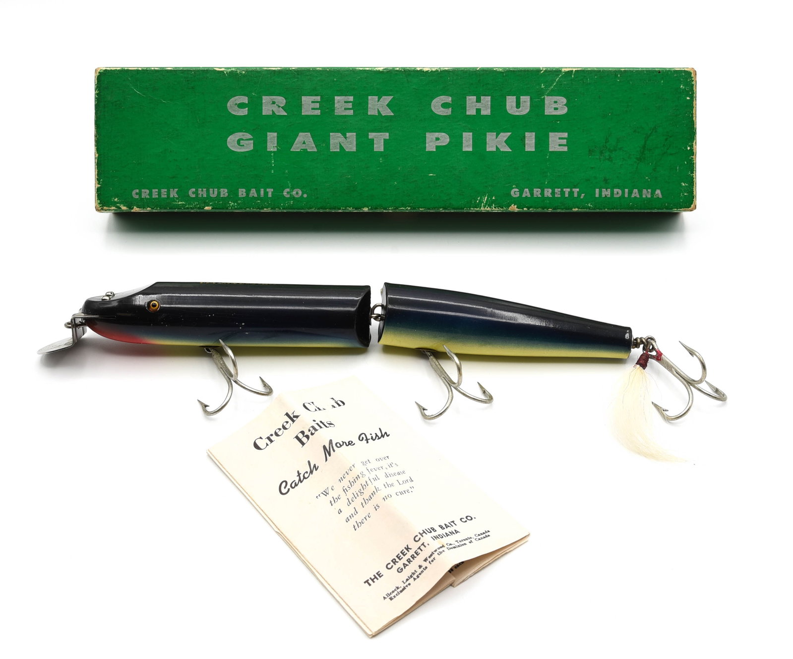 Creek Chub Giant Jointed Pikie: Finished in shiny purple eel with good glass eyes and bright gold back stamp, possibly unfished but small pointers/surface hook marks, slight box wear and tight age lines, so Ex-/Ex. The early green 2