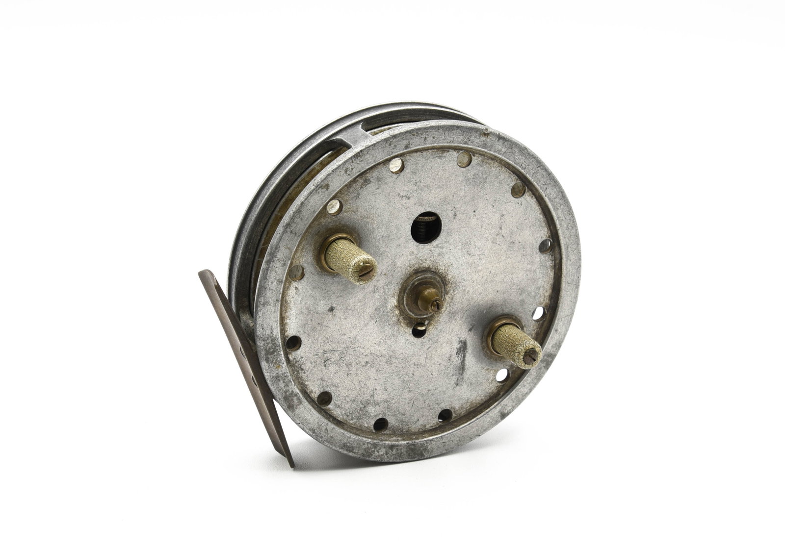 J.W. Young Perfection Flick 'Em Fly Reel: Centrepin with a 4" diameter and a narrow 1/2" wide spool, perforated face plate, full length smooth brass foot, rear mounted on/off check switch, and a tiny "Made in England" stamp on the tail plate.