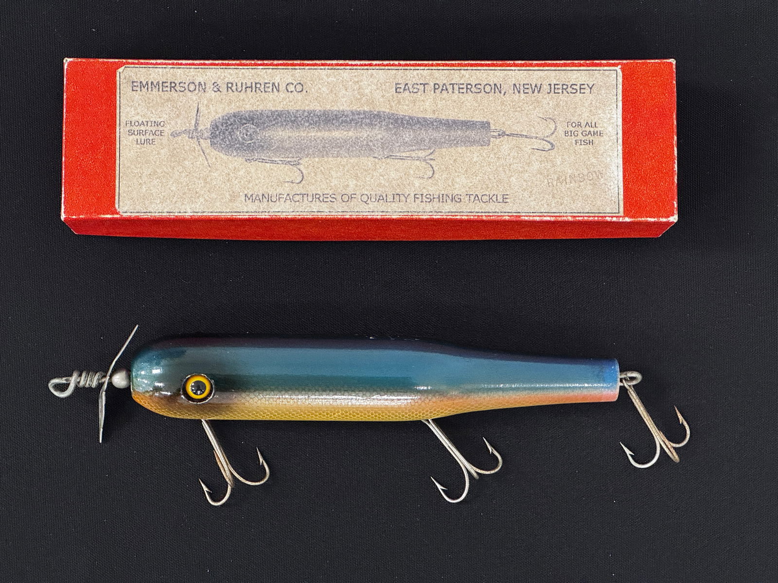 Emmerson & Ruhren Striper Plug: Seldom found surface lure finished in blue back with side scales, front floppy spinner and large good glass eyes, VG+/Ex- due to slight wear, small rubs, a few flakes, pointers and age lines, appearin