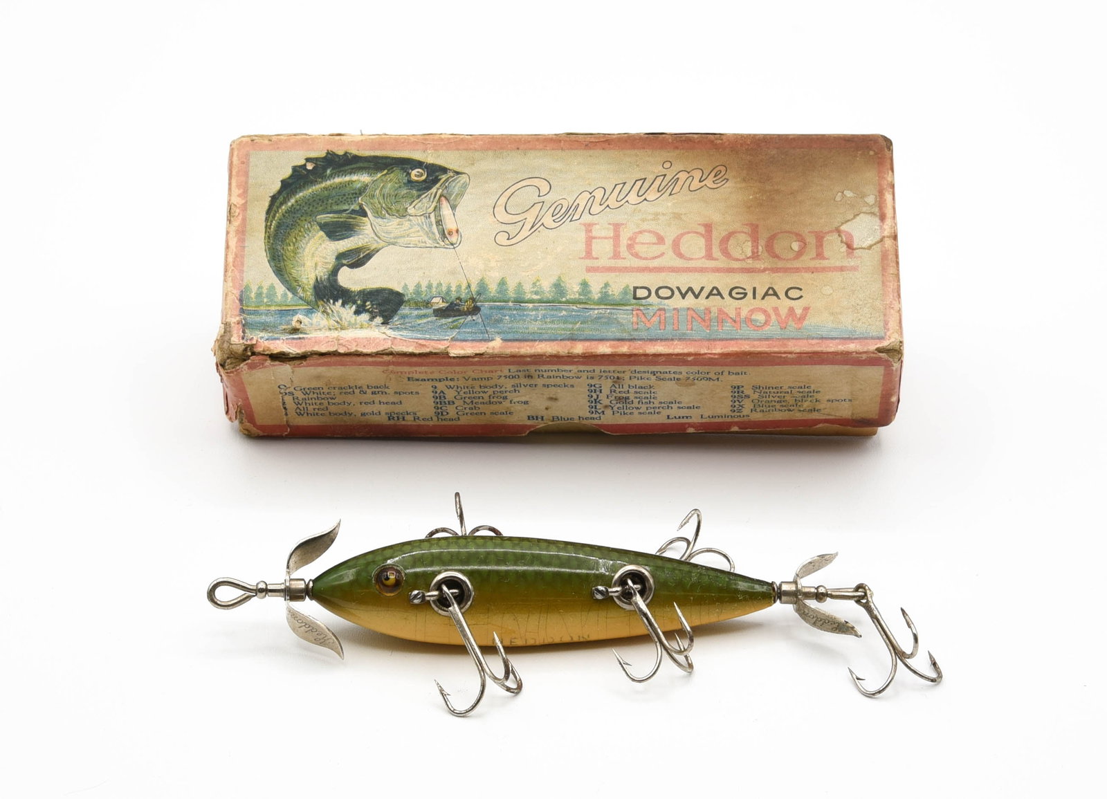 Heddon 150D Underwater Minnow: Clean L-rig hardware and marked props, with good glass eyes and belly stencil, if not for a couple of tail chips this shiny green scale minnow would grade Ex-/Ex. The correctly marked box is rough but