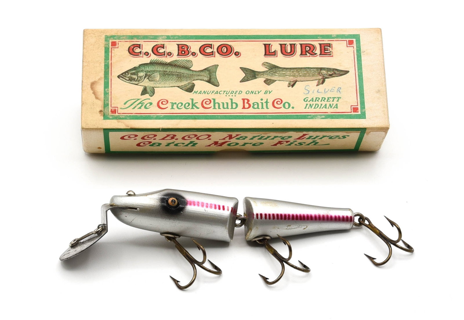 Creek Chub Jointed Pikie Special: Finished in rare silver with red side slashes and black eye shadow. This uncataloged #2600 features a deep diving lip, tack eyes and gold back stamp, and grades at least Ex-, with lower joints rubbed,
