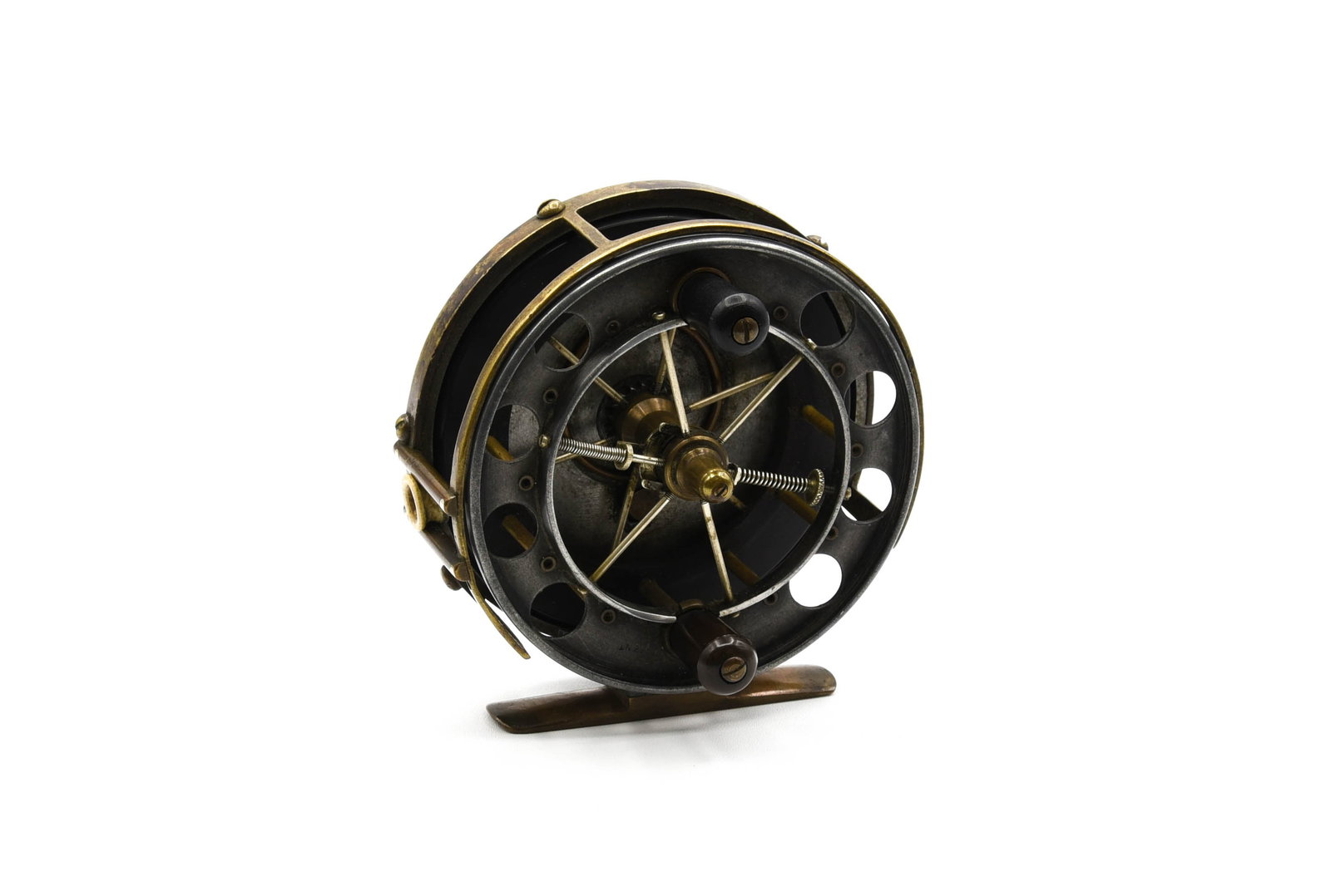 The "Allcock-Aerial" Reel: Brass, ebonite and alloy with a 3 1/2" diameter, 7/8" wide spool, twin handle grasps, an ebonite rear plate to accept the pinned arbor and a sliding check switch on the alloy tail plate. Stamped "The 