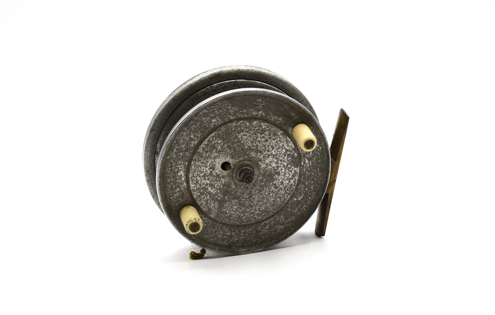 J.W. Young Perfection "Flick 'Em" Fly Reel: Centrepin with a 3 3/4" diameter and a 11/16" wide spool, unmarked, rear mounted on/off check switch and a full length smooth brass foot. VG/VG+ condition due to tarnish and moderate wear.