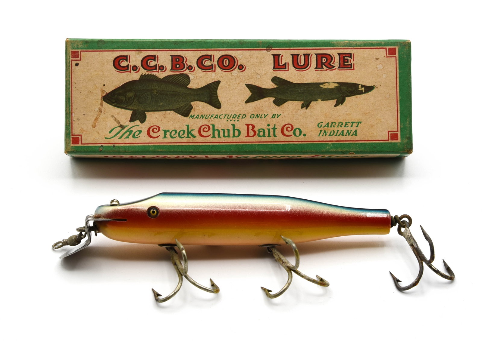 Creek Chub 2308 Husky Pikie: Bright blue back rainbow finish, rigged with heavy duty strap hook hangers and reinforced lip, if not for hairlines in one eye this shiny lure would grade near Ex. The extended box is stamped 2301 (pe