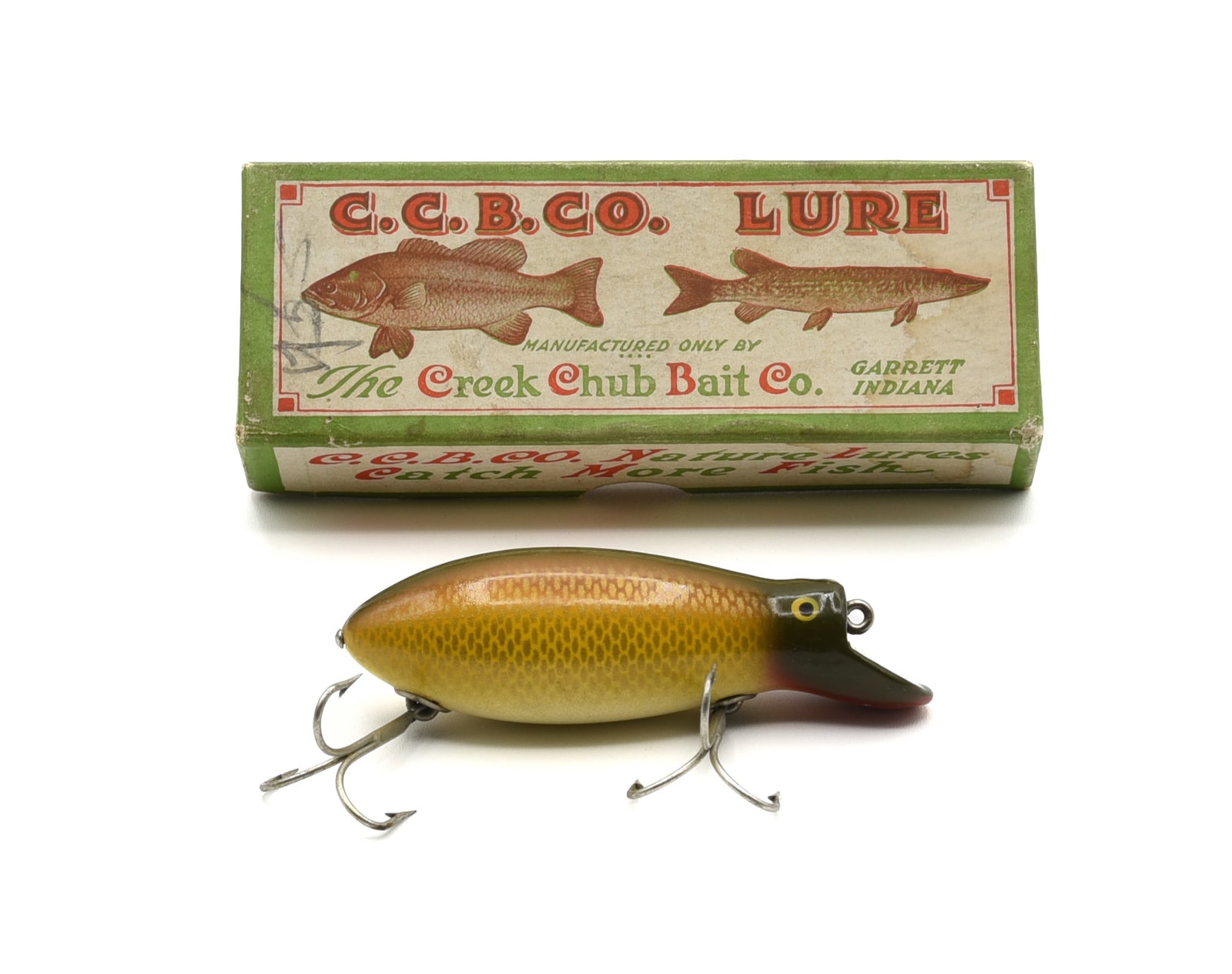 Creek Chub 6704 Big Bomber: Scarce musky bait, the largest of the Bomber/Kreeker series, finished in bright golden shiner, appearing unfished, shiny Ex-/Ex with only very slight wear, couple of chin pointers and faint age lines.