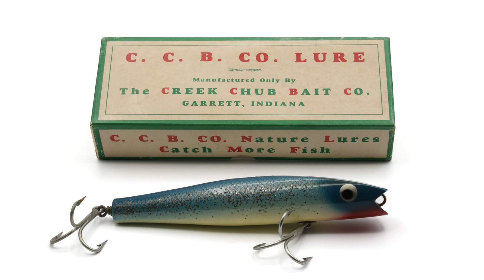 Creek Chub 7634 Surf Darter: 7" Surf Darter with a single mouth line tie, blue flash finish, Ex-/Ex, bright and shiny with only light wear and bleed-thru started, appearing unfished. The box is clearly stamped 7634 and also grade