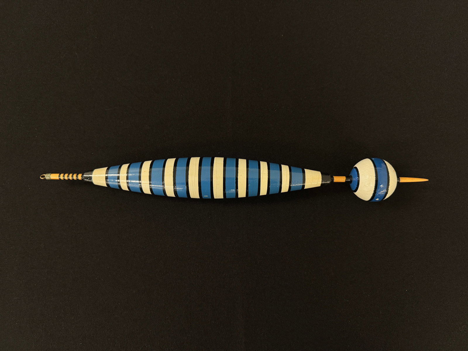 Custom Ideal Float: Rare 15 3/4" painted cork bobber with an attractive blue, white and black striped pattern, in near excellent condition (a few tiny chips, soiling and age lines). Dating from the 1950's, this important