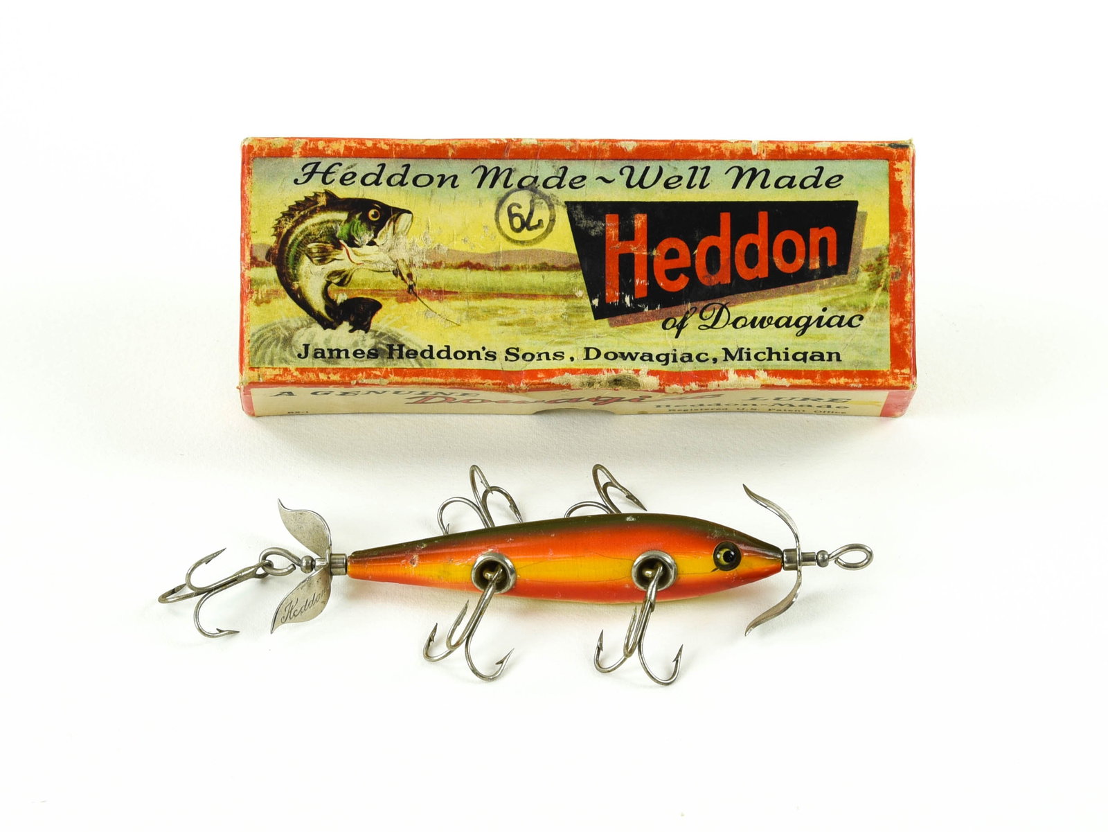 Heddon 5hk Underwater Minnow: Finished in early rainbow with hand painted gill marks, cup hardware, marked props and good glass eyes, about VG+ due mostly to a tail chip, wear, pointers, a few flakes and age lines. The box is