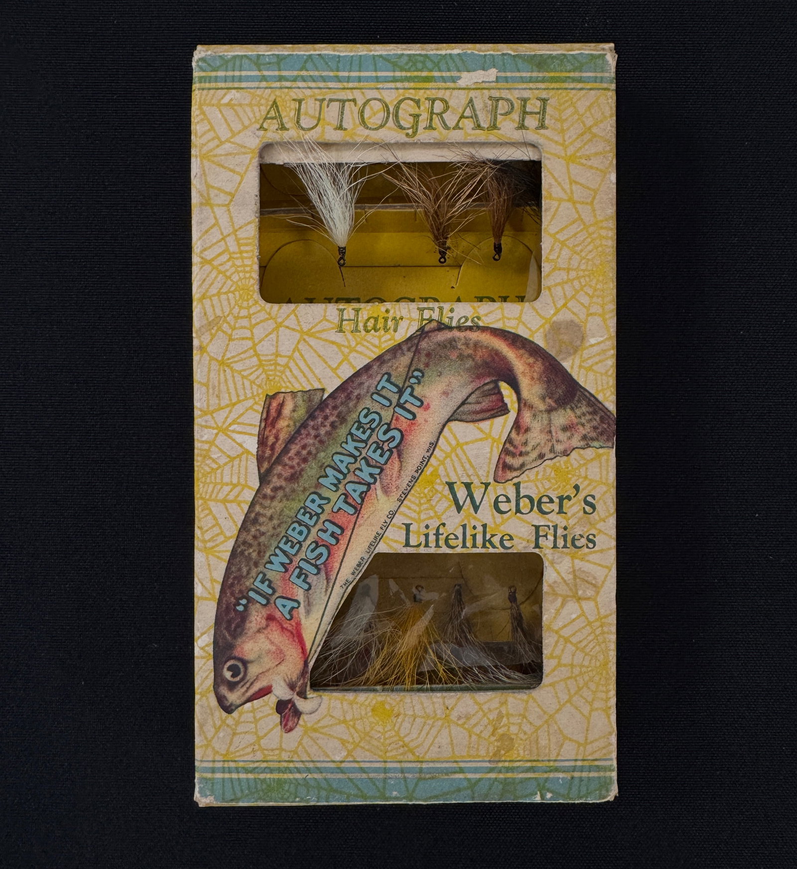 Early Weber Autograph Fly Box: A rare colorful box of Weber's Lifelike Flies with the original yellow insert card and 9 dry flies. With wear, light soiling, several flaps separated but present, and one cellophane window missing the