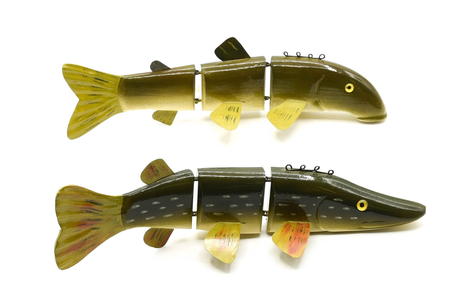 Lawrence Bethel Fish Decoys: Two large jointed Lawrence Bethel (1930-2006) fish, each measuring 12" in length and featuring glass eyes, pig-tail line tie and painted metal fins. Hand signed by the carver with his trademark B stam