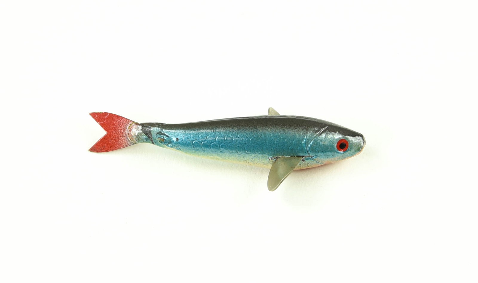 Vintage Caledonia Minnow: Later 3 1/2" (including tail) Caledonia style minnow, unmarked and unrigged, the body appearing to be rubber with metal fins/tail, airbrushed finish, and scale detail. About VG+ due to light wear, a f