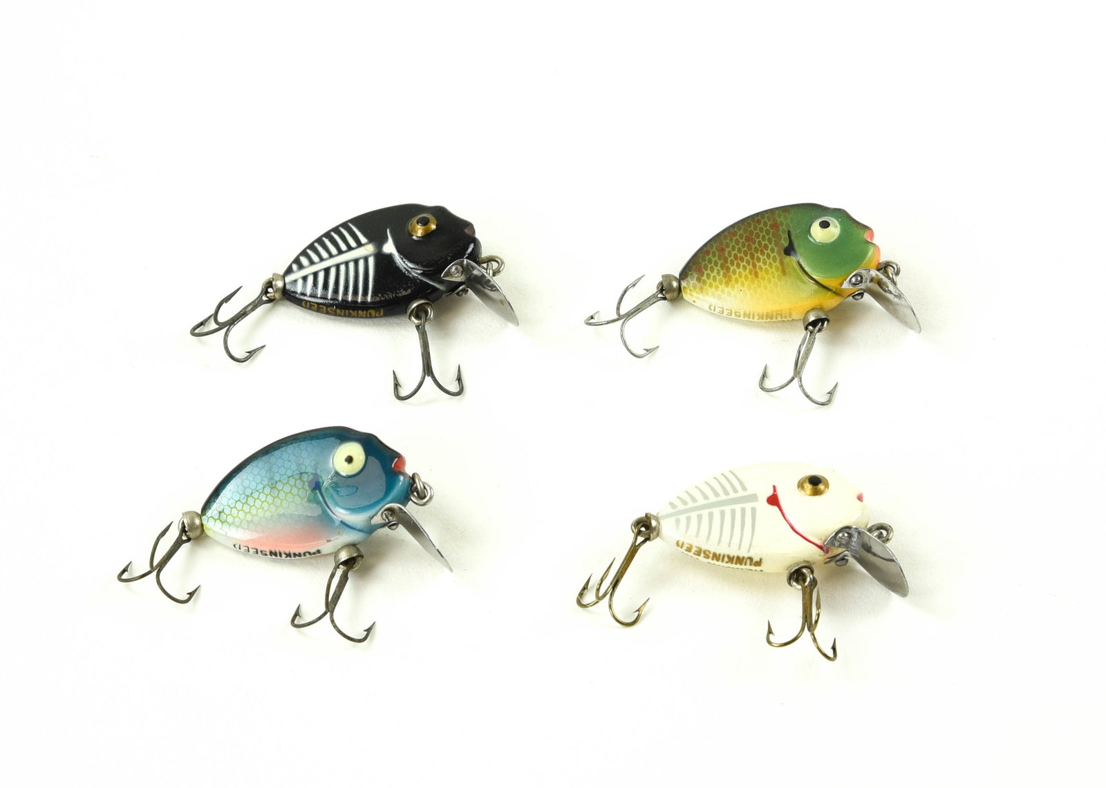 4 Heddon Tiny Punkinseeds: All belly stenciled and appearing unfished. Colors include: black shore, white shore, bluegill and sunfish. Condition from Ex- with light wear to shiny Ex.