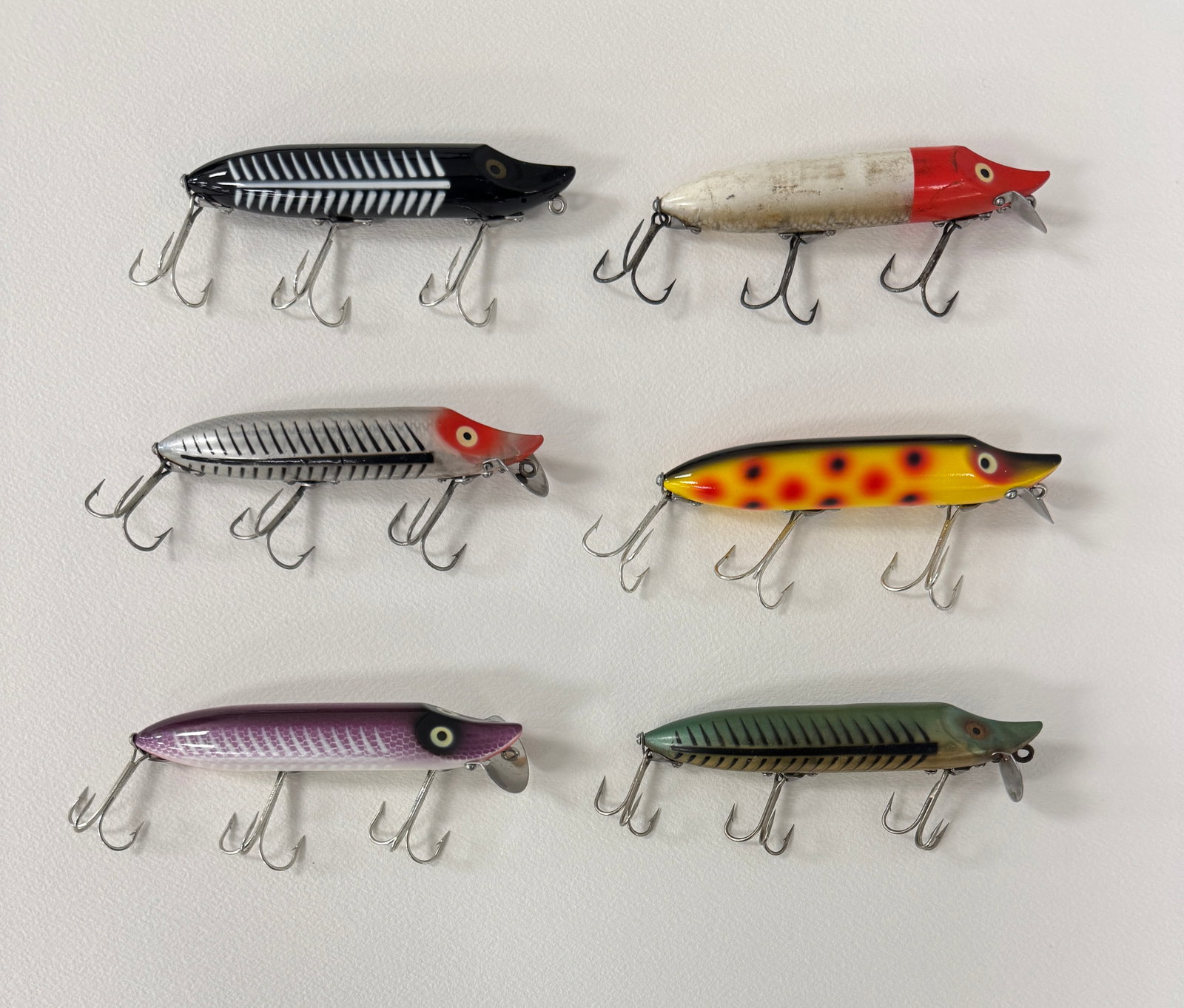 6 Heddon Vamp Spooks: Most are later models, all rigged with surface hardware and belly stenciled. The red/white grades VG+/Ex- otherwise the condition is Ex- to unfished Ex, bright and shiny.
