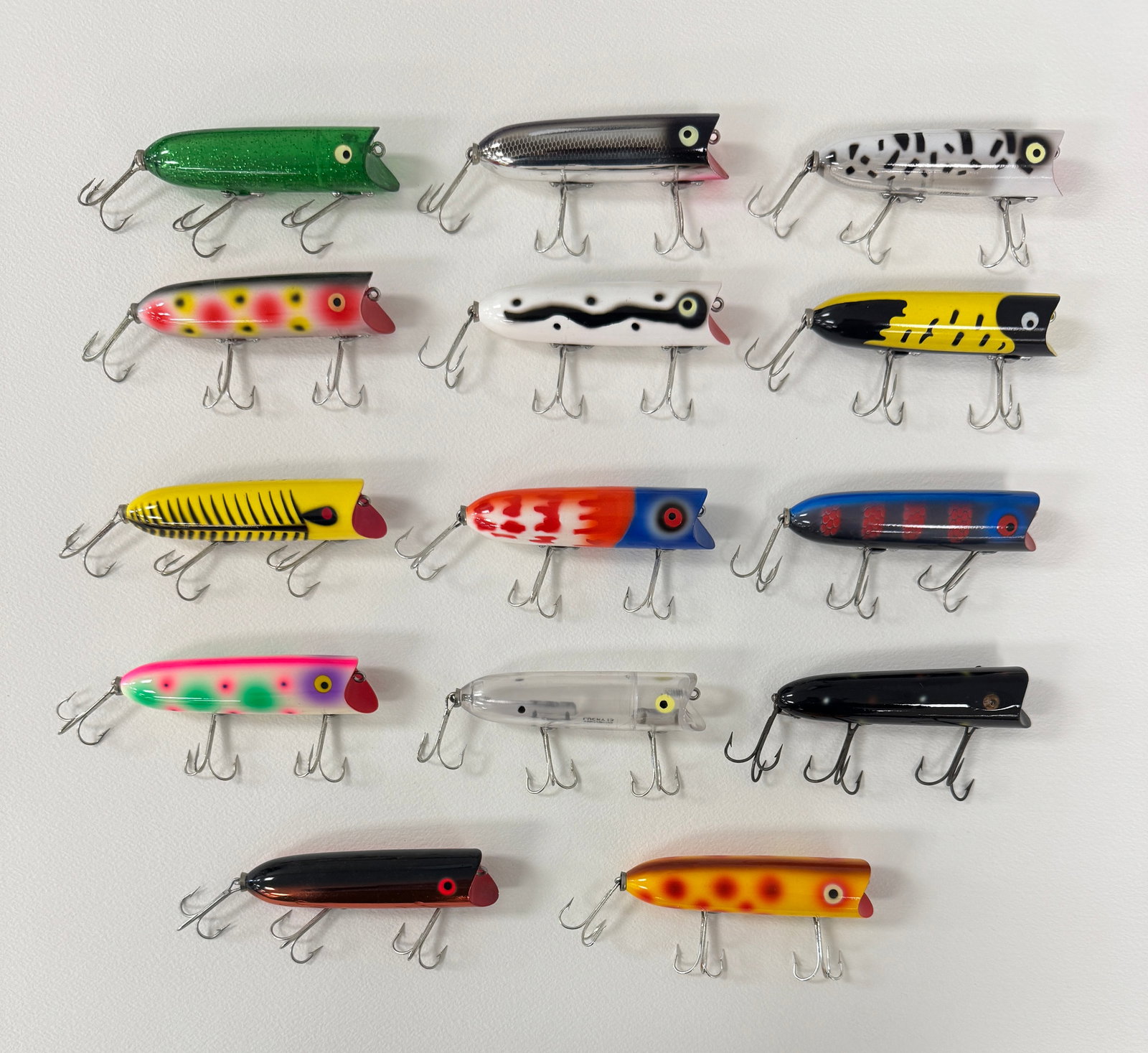 14 Heddon Lucky 13 Spooks: Plastic models with surface hardware and all but one with bell tail hardware, belly stenciled, unfished, and in vibrant colors.