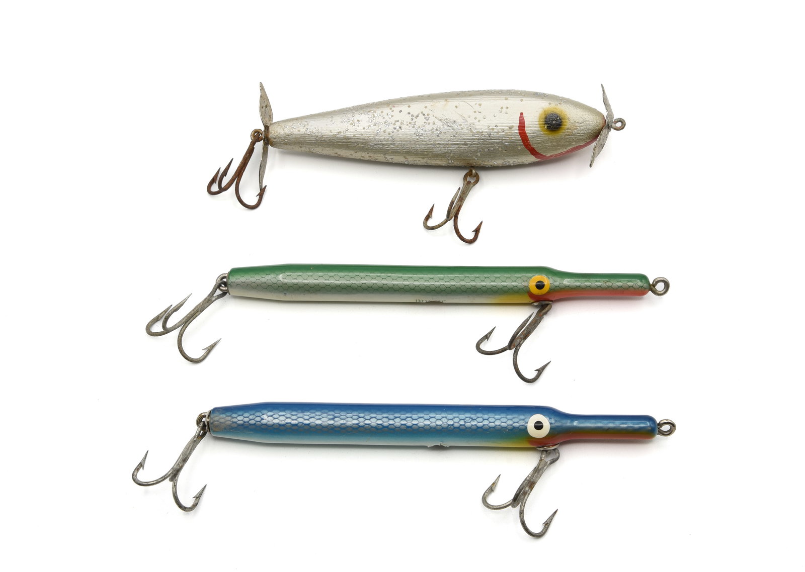 Sailfish Shiner & Boone Bait Co. Needlefish: Two 7" Boone Needlefish, each with paint off the belly weight otherwise possibly unfished. And a large 6" Sailfish Shiner with red hand painted gills and chin, air-brushed eyes, 4 belly weights, wood