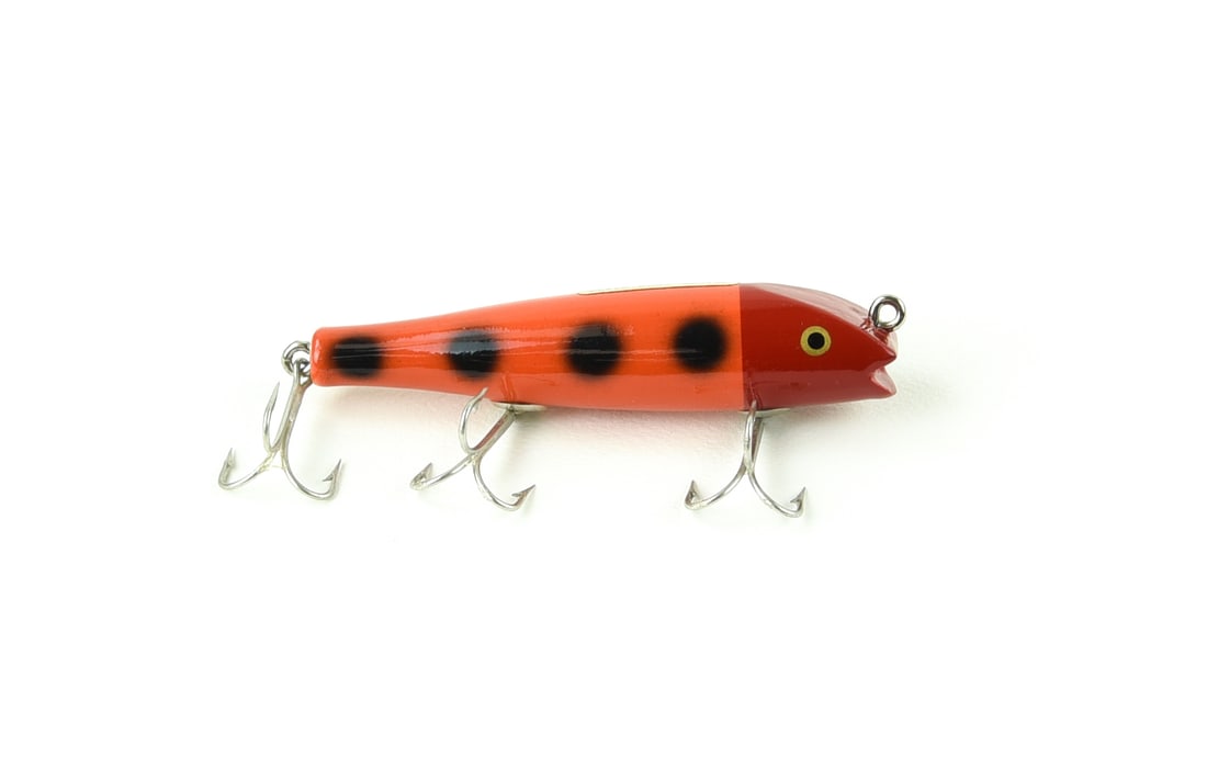 Creek Chub 2030 Darter Special: Bright shiny finish on this 2000 in red head orange with black spots and near perfect gold foil decal, unfished Ex, with no sign of use and clean hardware. A hard to find bold Special Order color on t