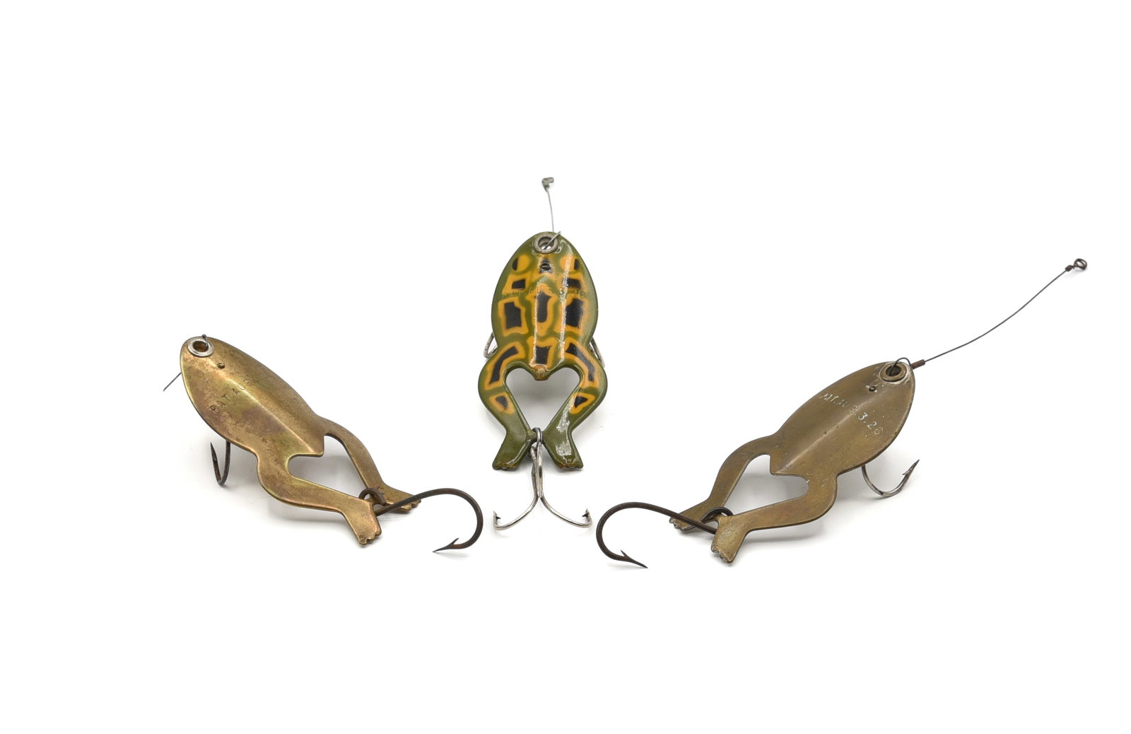 3 Heddon Spoon-y Frogs: All marked with the 1926 patent date and all belly marked Heddon Spoon-y Frog. Colors include: frog, other than a replaced hook the condition is near Ex, brass (VG+, broken leader), and nickel (about