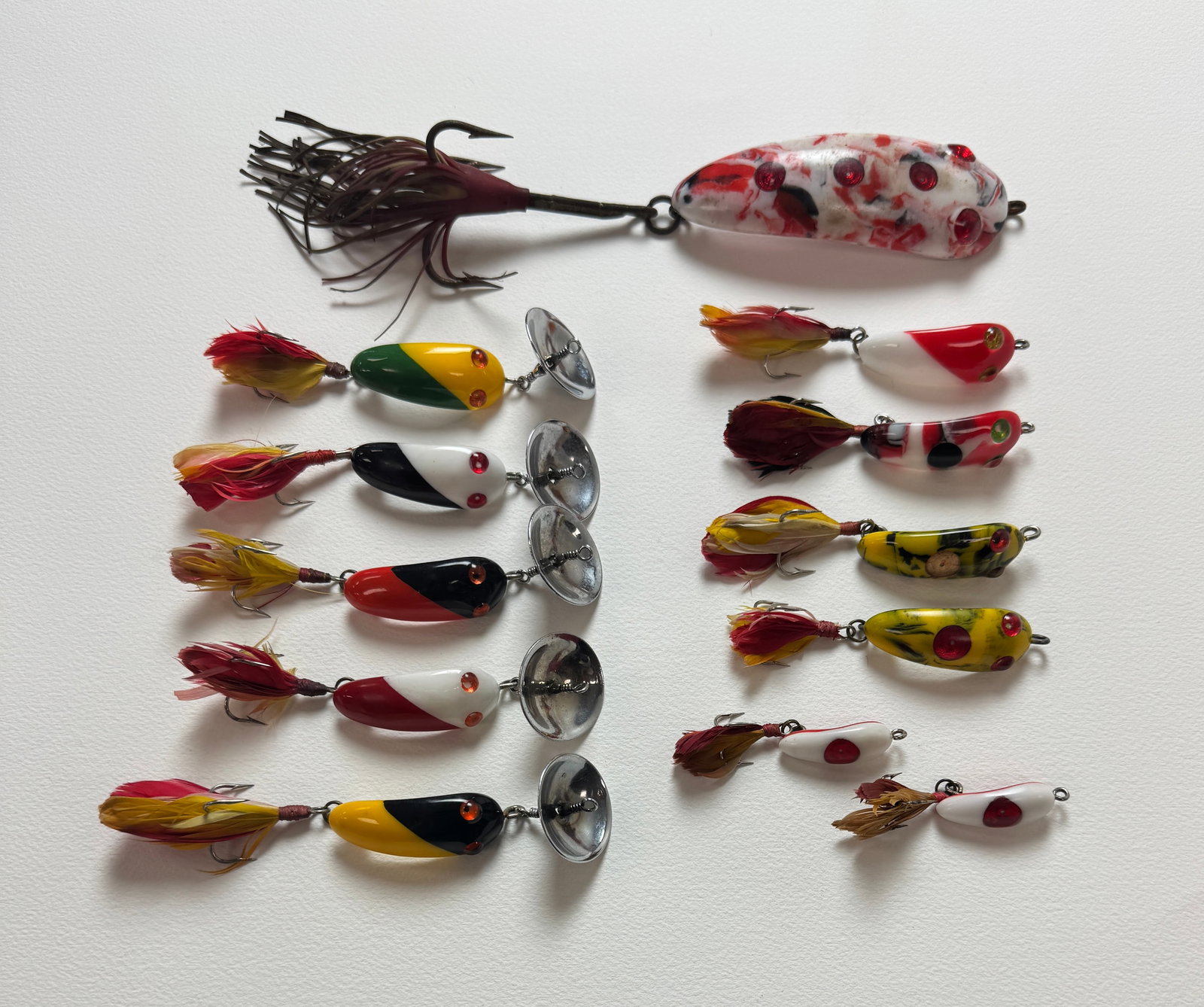 12 Vintage Canadian Baits: A nice group of colorful lures, several models in multiple sizes, including a musky with its body measuring nearly 4 1/2" in length. The cupped spinners are stamped Pat. Pend. and Made in Canada.