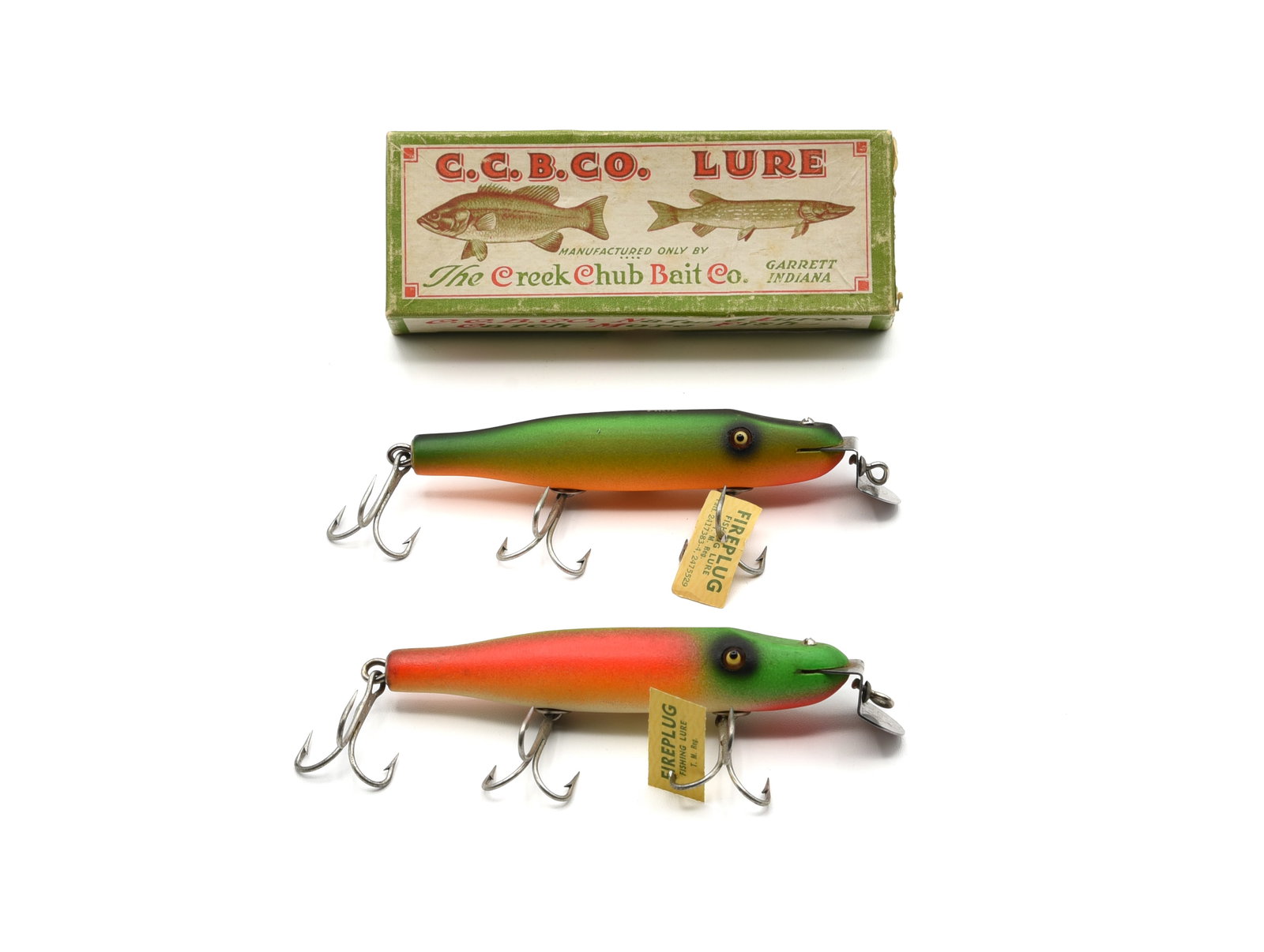 Creek Chub Fire Lacquer Pikies: 732 and 731, both with good glass eyes, gold back stamp and paper factory tag. Fireplug is unfished Ex with only one small pointer, rainbow fire grades Ex-/Ex with only slight wear, soiling and a few 
