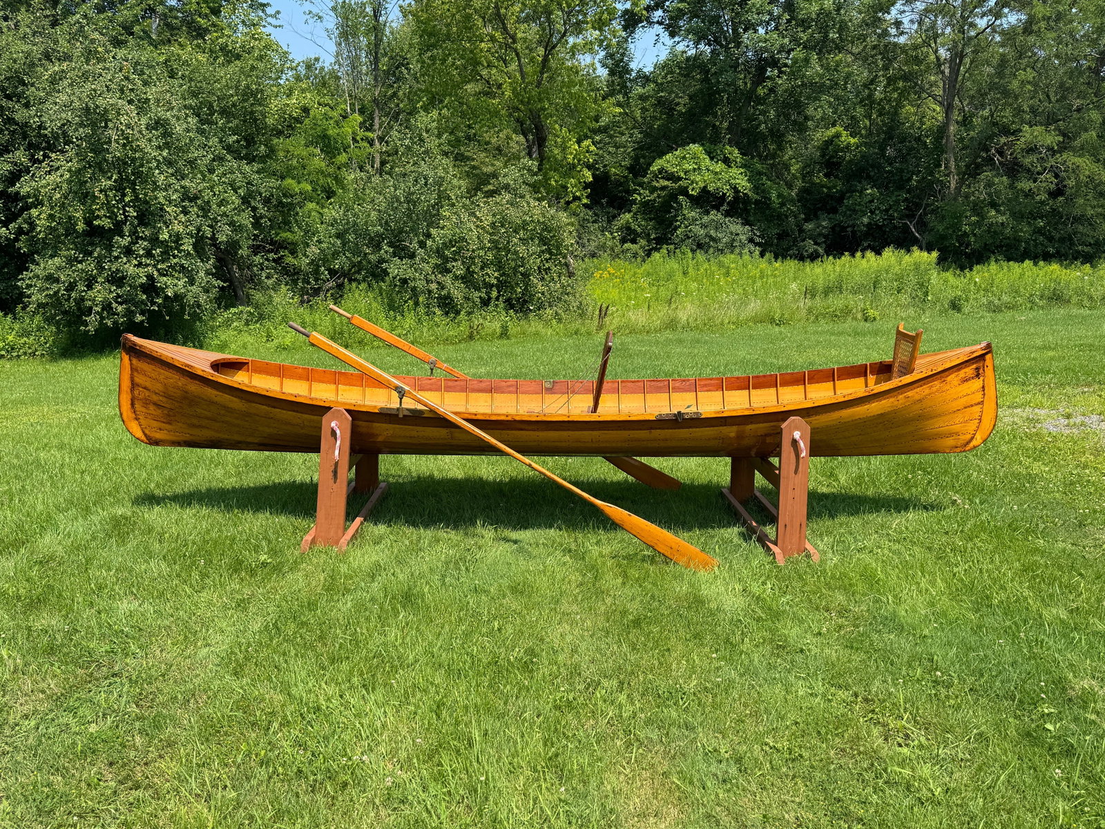 Martin 15 1/2' Adirondack Guideboat: Natural finish inside and out. Red cedar sheer streak and alternating red cedar and pine decks. Brass oar locks. 39" wide. Good usable condition. Includes a pair of 94" guideboat oars. From Whitney Pa