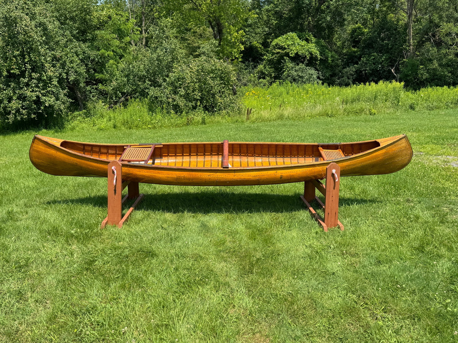 Adirondack Smooth Skin Canoe: Attributed to Moody from Saranac Lake. Early 1900s. Made of cedar. 14.5' long. 31" wide. Caned seats, natural finish inside and out. Good usable condition. From Whitney Park, Adirondacks.