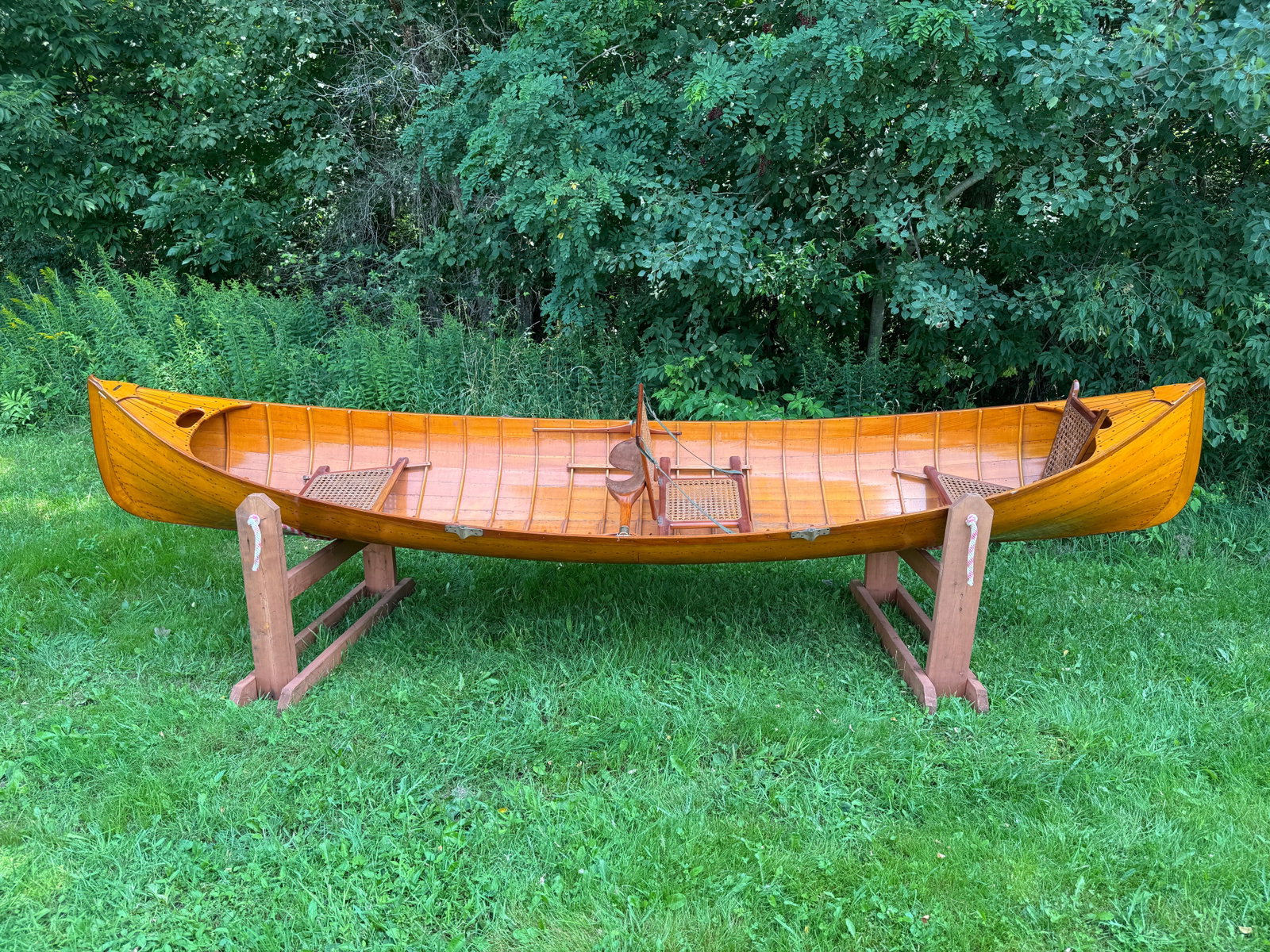 Hanmer Adirondack Guideboat - 13.5' long: Beautiful natural finish inside and out. Made in Saranac Lake, NY with original brass label. Caned seats and carrying yoke. No oars. From the Andrew Schuler Collection, Founder of Schuler Potato Chips