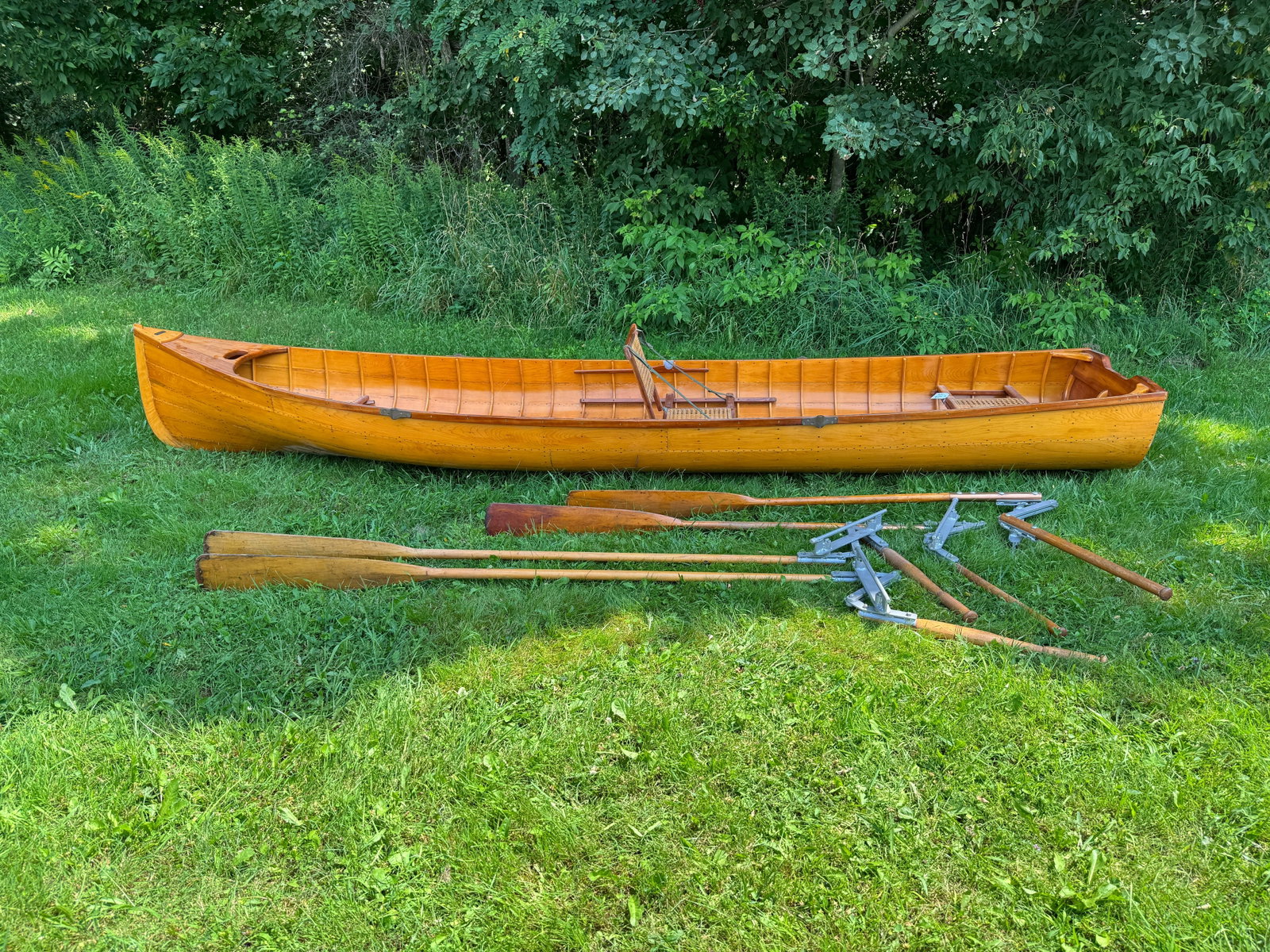Hathaway Boat Shop Adirondack Guideboat: Square Stern Guideboat made in Saranac Lake, NY with original brass label. Beautiful boat in all natural finish inside and out. Caned seats, removable floor boards, brass oar locks, 2 sets of mechanic