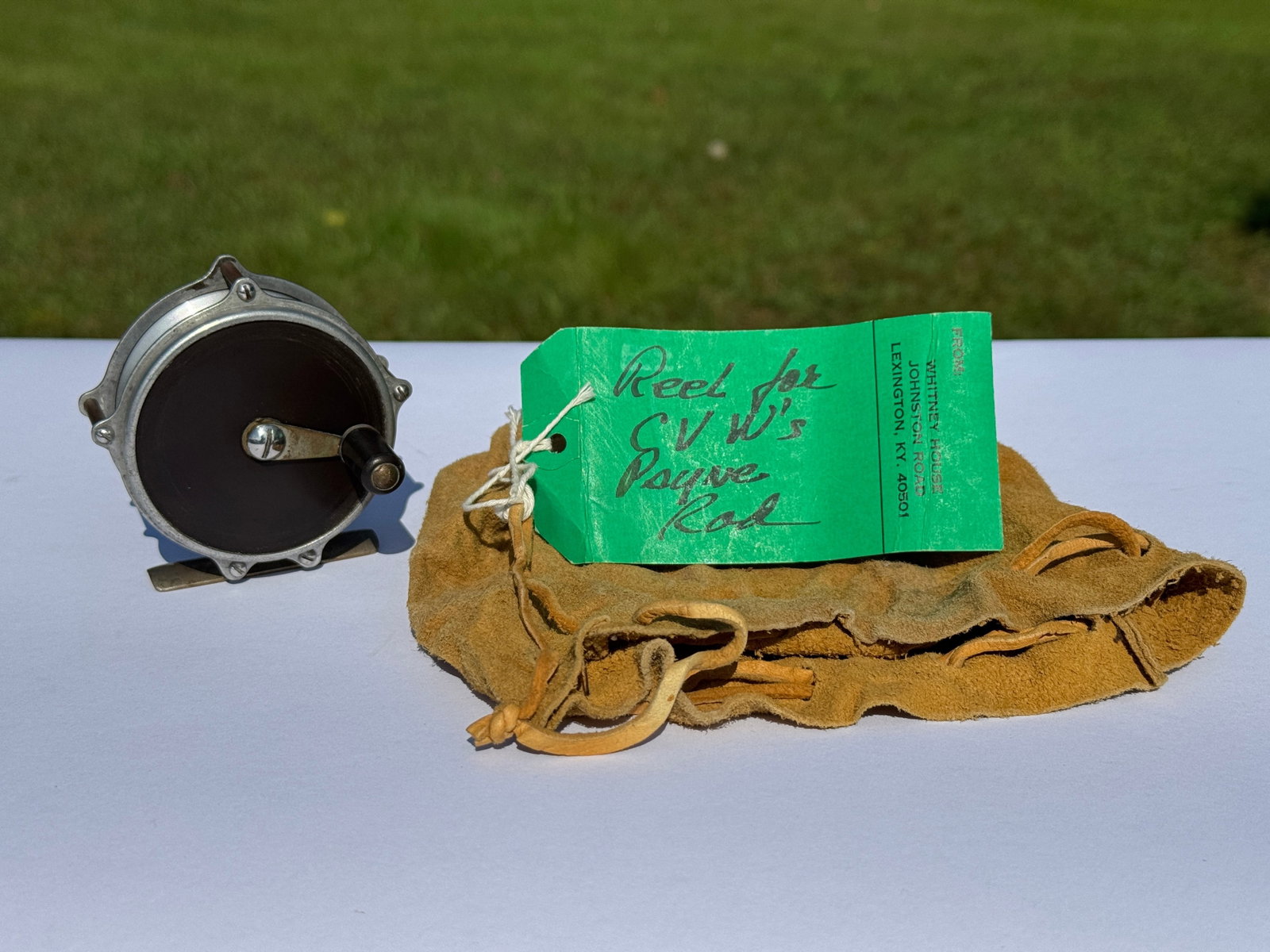 Leonard Mills Raised Pillar Trout Reel: owned and used by C.V. Whitney. 2 5/8" diameter. With leather bag and tag that reads: Reel for C.V.W Payne Rod. From Whitney Park, Adirondacks.