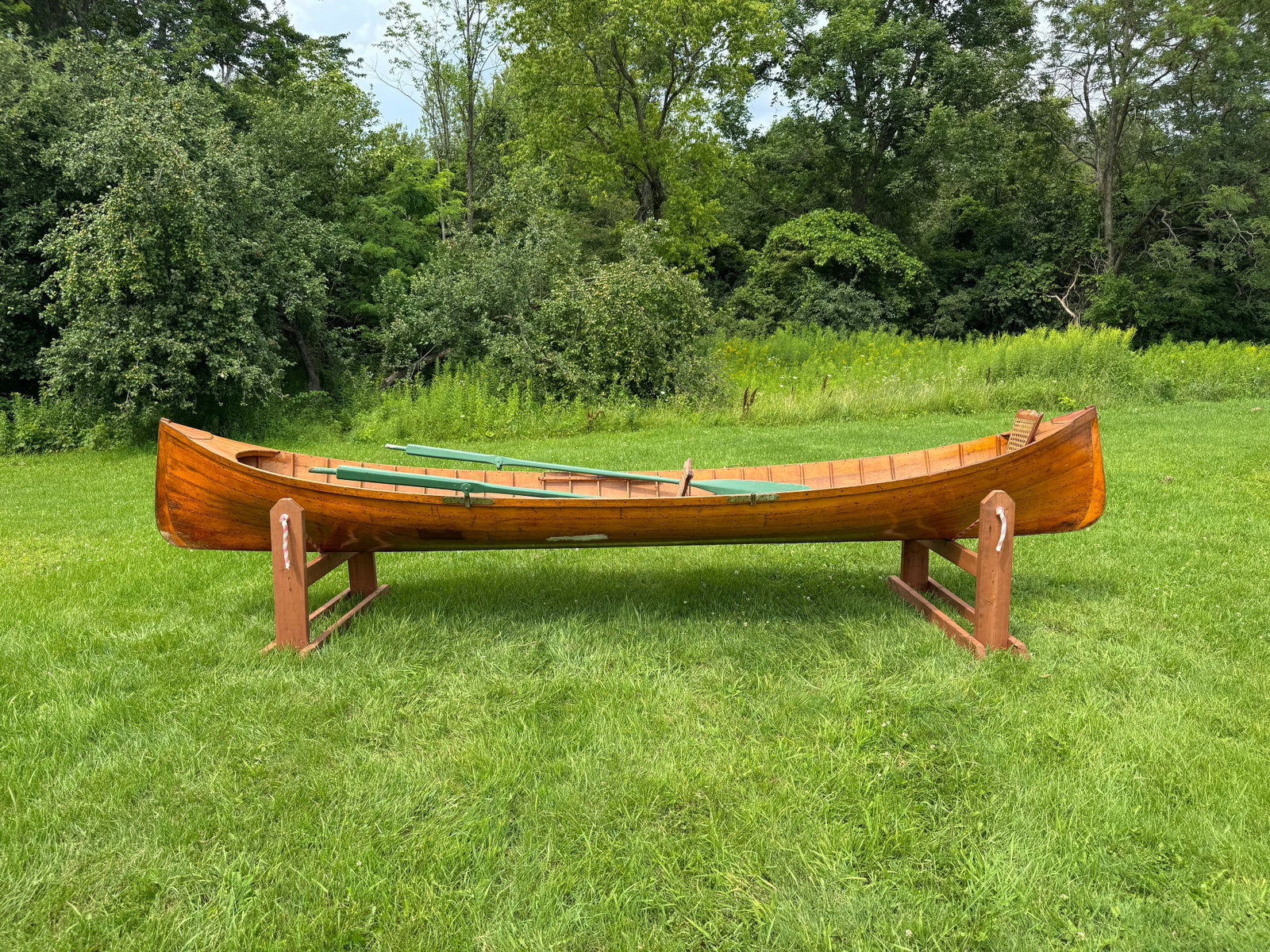 Adirondack Guideboat - 15' long: Natural finish inside and out., green painted oars, center seat needs caning. This is a solid boat that need a good cleaning and light restoration. It could be restored to be used or would display wel