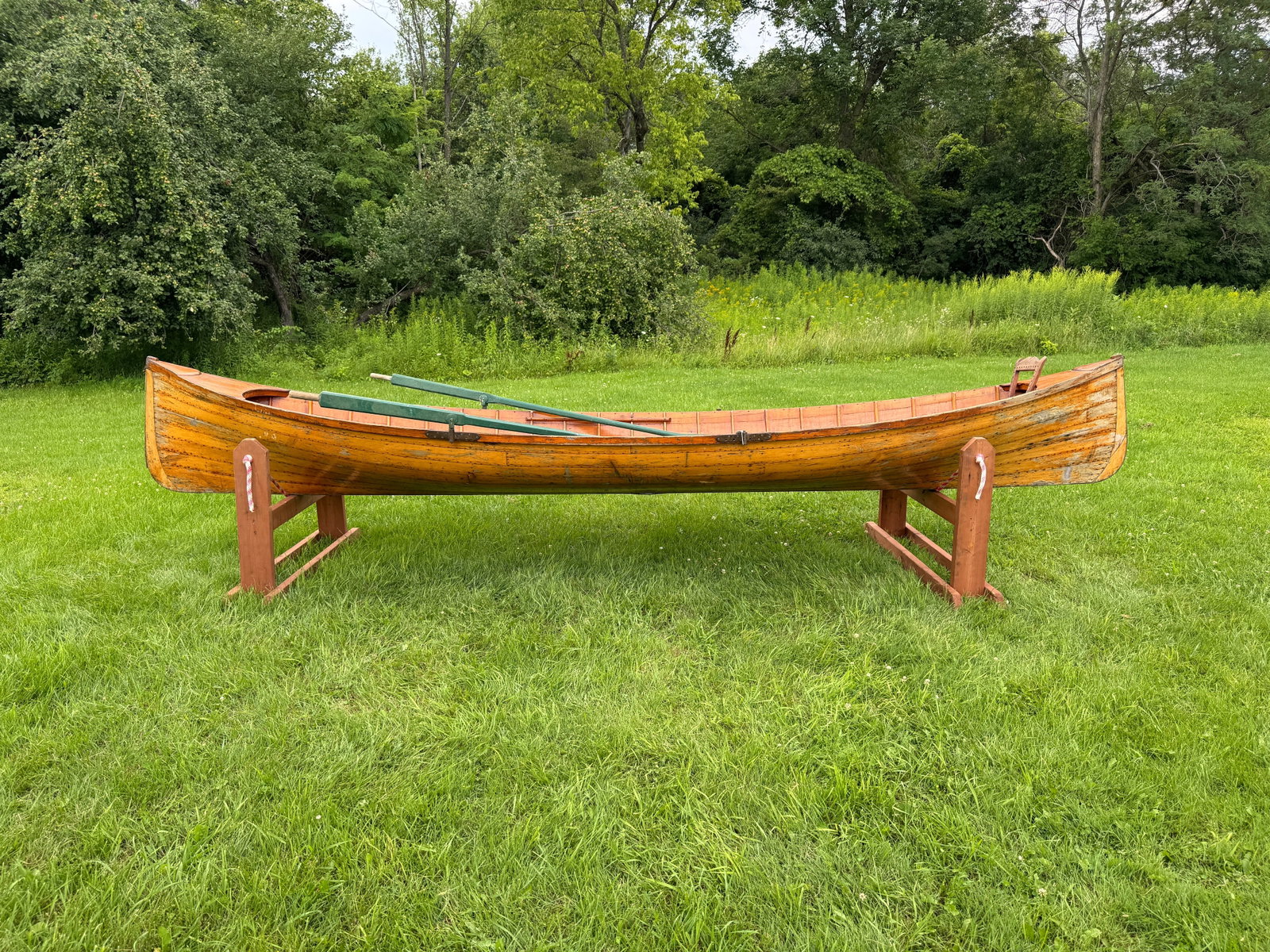 Adirondack Guideboat - 15' long: Natural finish inside and out. The boat is solid and in overall good condition, oars included, exterior finish is flaking off, a couple of cracks needs filling. Needs minor restoration includes seats 