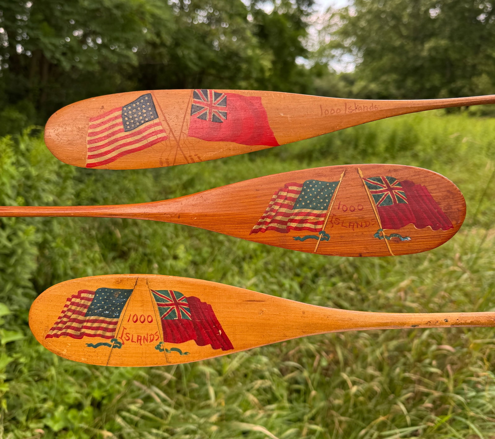 3 Thousand Islands Souvenir Paddles w/ Flags: in the style of Keech. Each 22" long. From the Estate of Dr. Dean Hyde, Clayton, NY.