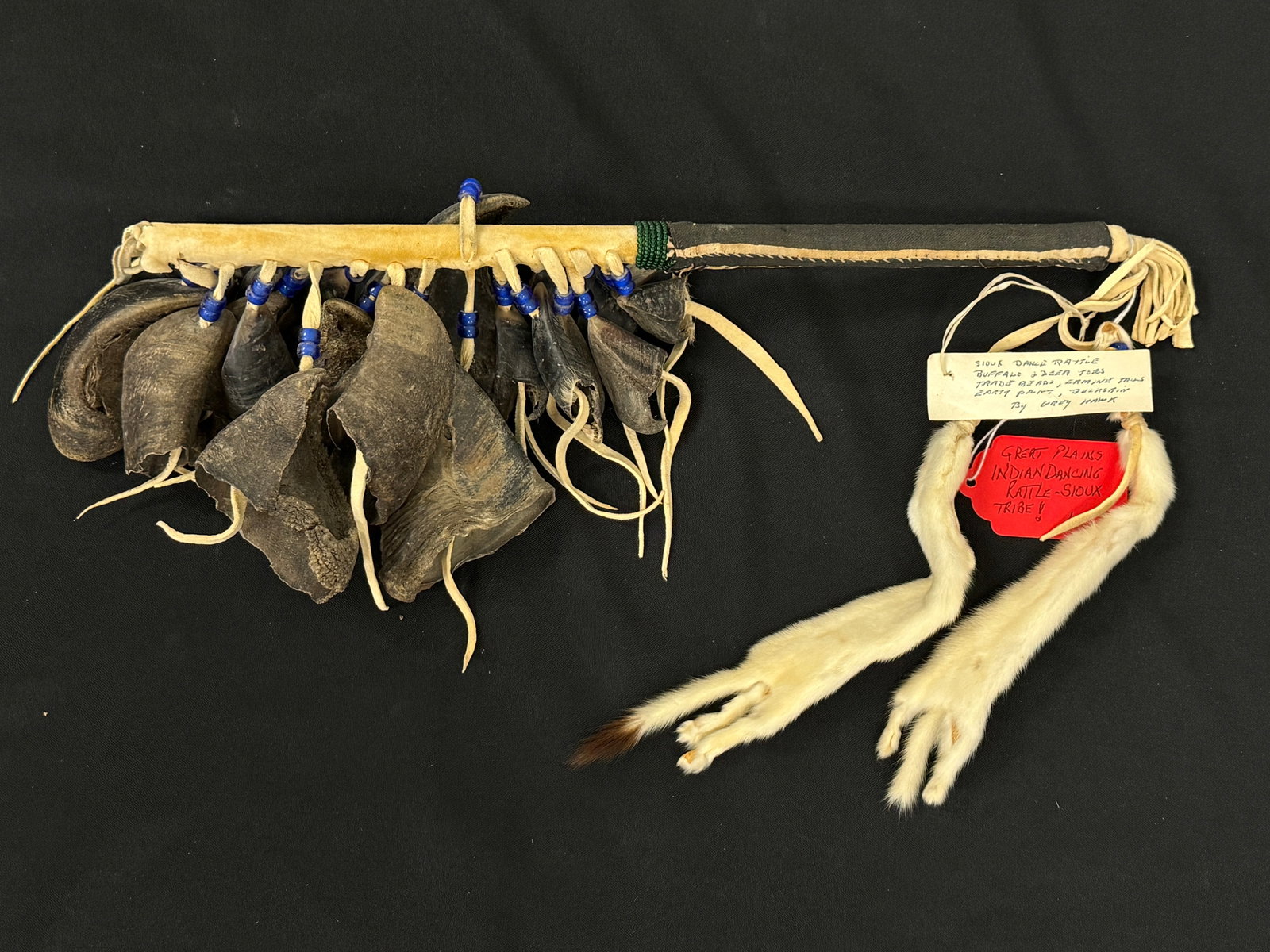 Great Plains Indian Dancing Rattle: Sioux Tribe. Made of Buffalo and deer toes. Made by Grey Hawk. 17" long