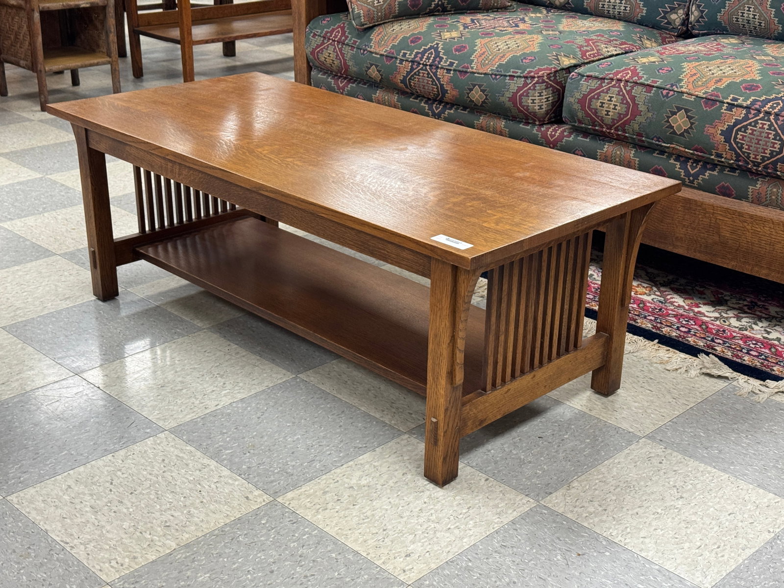 Stickley Quarter Sawn Oak Coffee Table: marked no. 32 and stamped 89-757. Spindle ends. 48" x 22" x 17.25" tall. Finish in good condition.