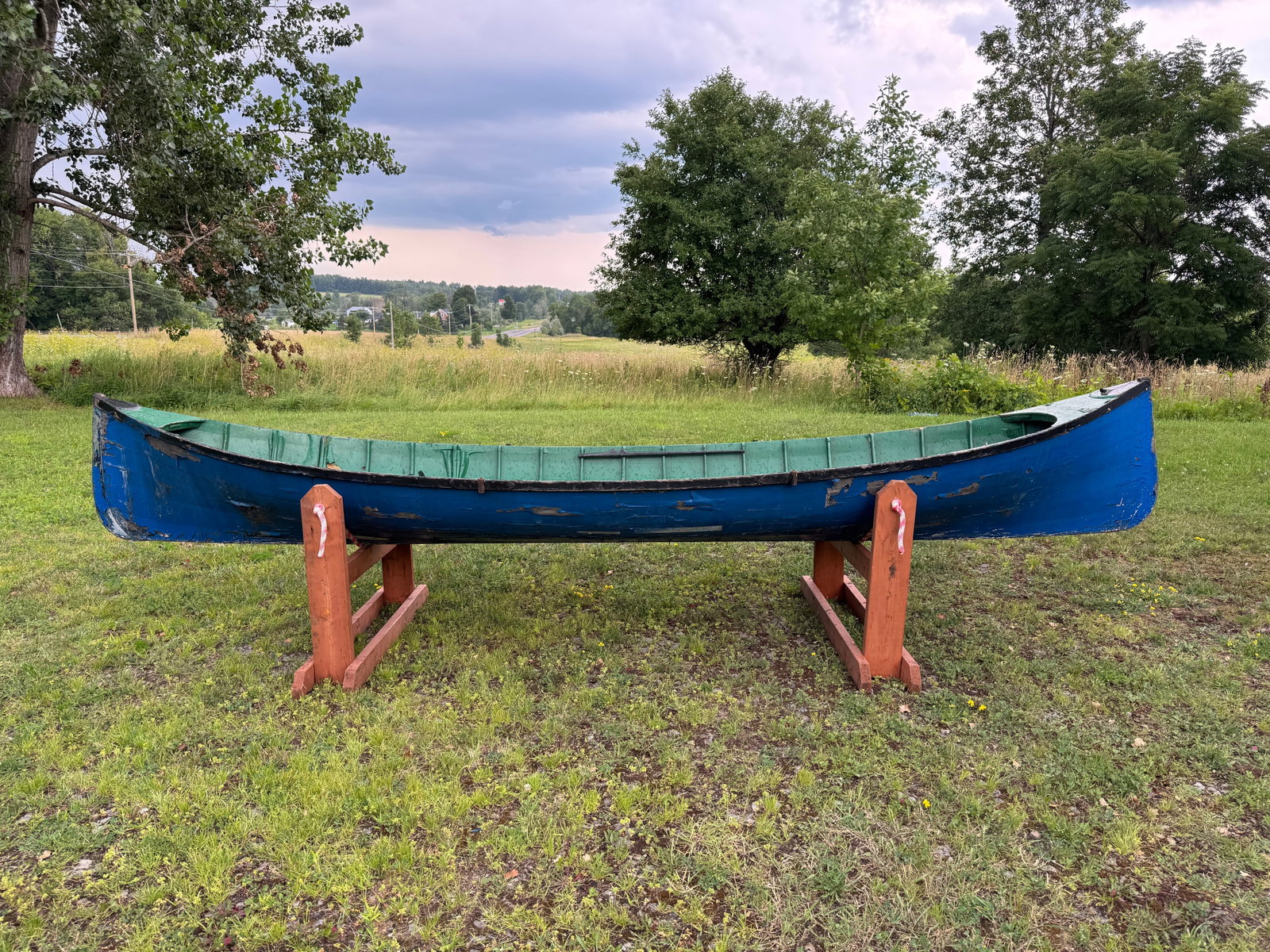 Adirondack Guideboat - 14' long: painted blue exterior, green interior. Smooth Skin construction, 41" wide. Needs restoration. This boat has been in storage in the carriage barn at Whitney Park for the last 50 years.