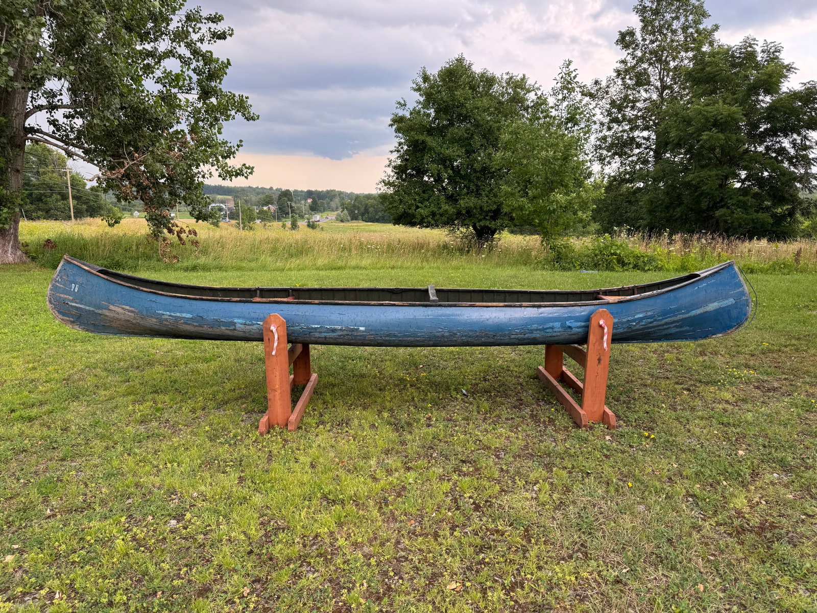 A.B. Moody Smooth Skin Canoe: 16' long x 32" wide. Painted blue exterior, green interior. Needs restoration. This boat has been in storage in the carriage barn at Whitney Park for the last 50 years.