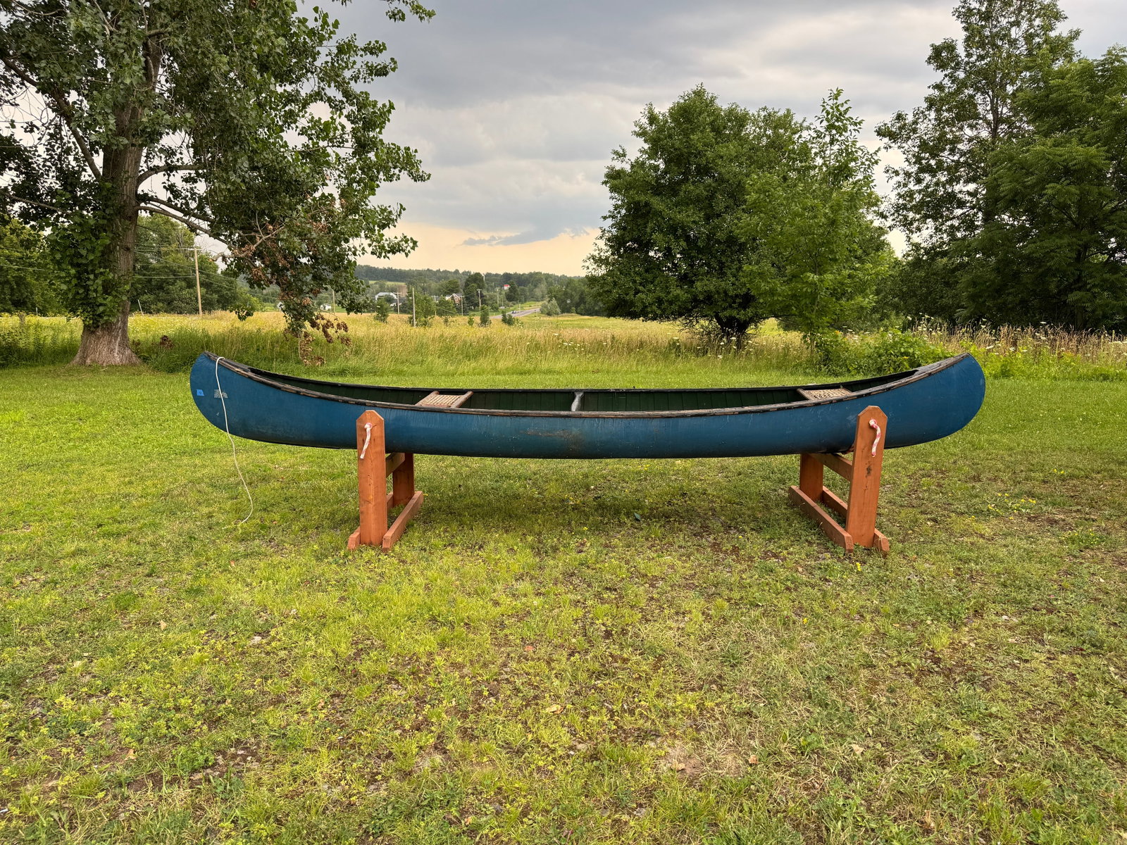 Wood Canvas Canoe - 14.5' long: painted blue canvas with green interior. 34.5" wide. Needs new canvas. This boat has been in storage in the carriage barn at Whitney Park for the last 50 years.